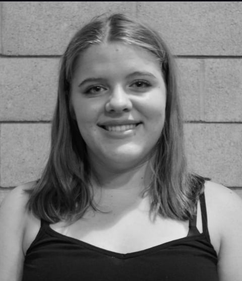 Black and white portrait of a smiling young woman with shoulder-length hair